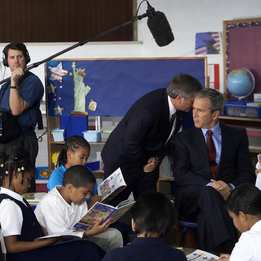 President Bush notified of September 11 attacks in Florida classroom, 2001 — boom mic operator standing in the doorway just outside frame